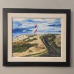 A Framed original acrylic painting of a Newfoundland lighthouse standing on a rugged rocky coastline beneath a brilliant blue sky overlooking the Atlantic Ocean