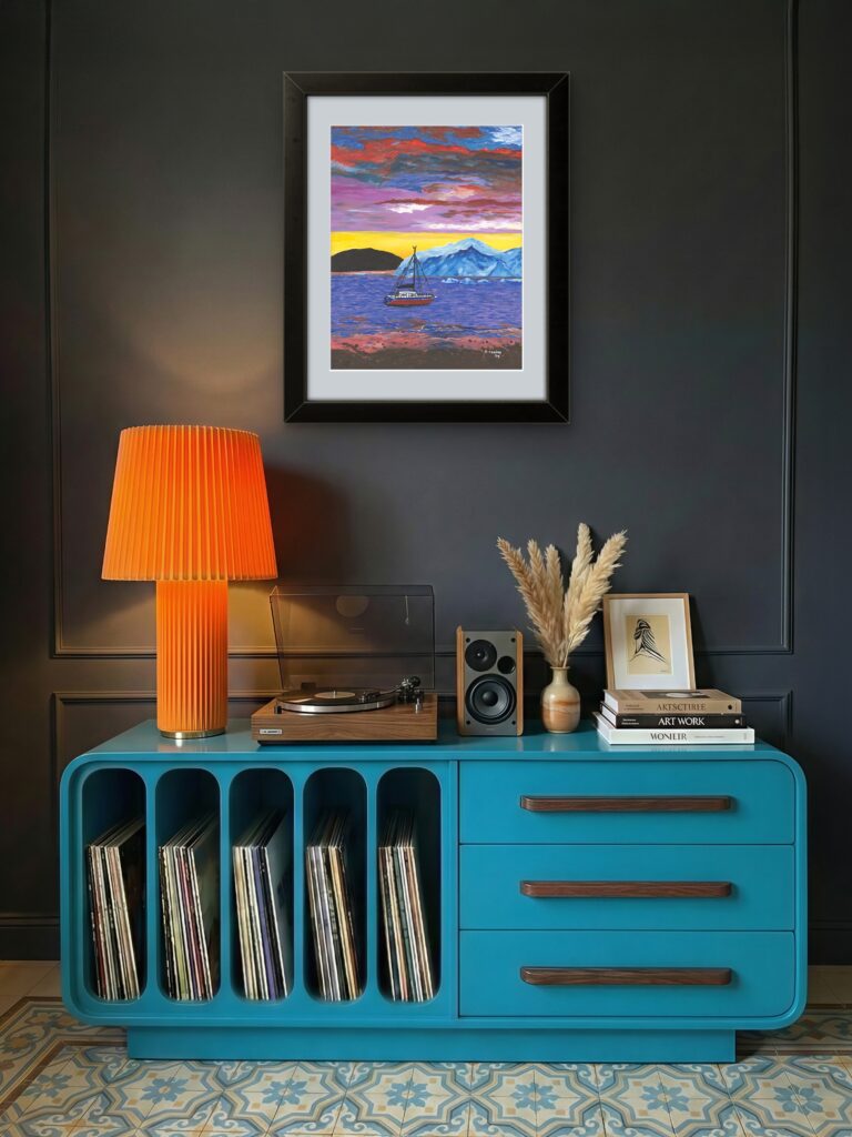 Print of original acrylic painting of a boat cruising past a majestic iceberg at sunset off the coast of Newfoundland, beneath a colourful evening sky.